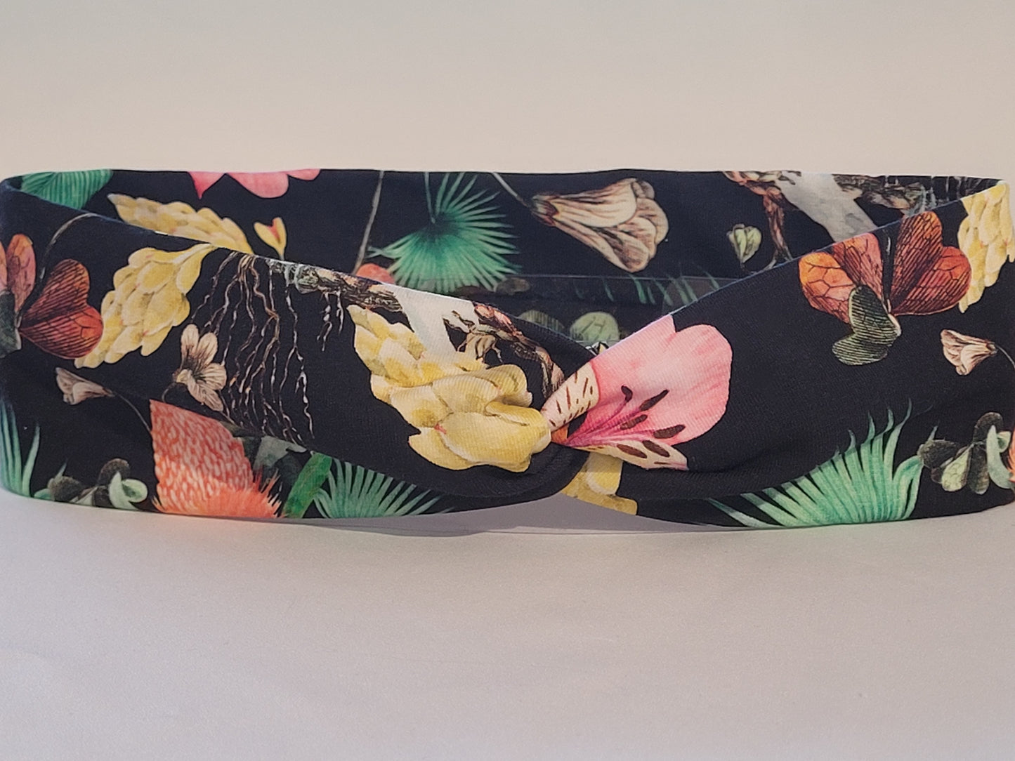Schwarzes Knotenhaarband mit tropischen Blumen